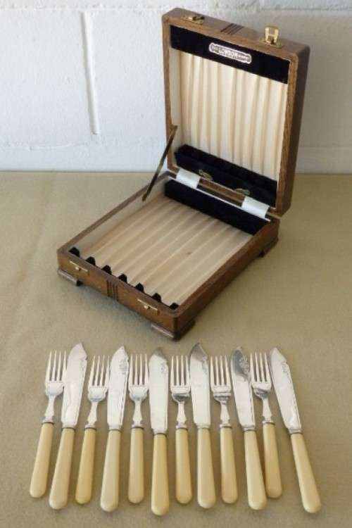 A stunning vintage bone handle style "fish knife and fork" set in its original wooden canteen