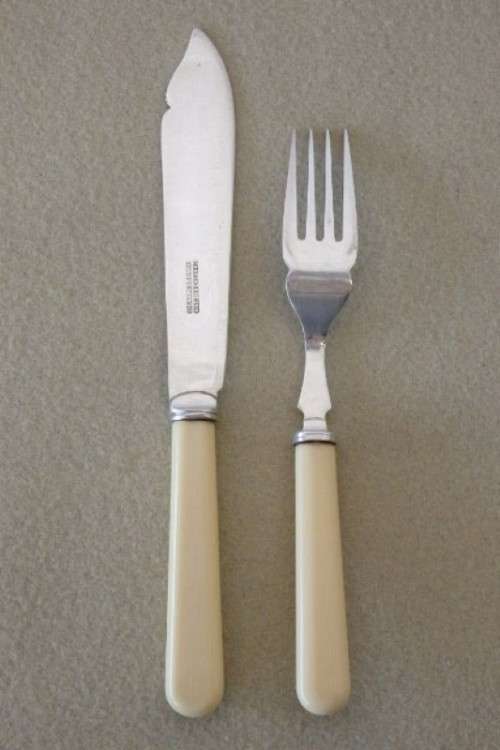 A stunning vintage bone handle style "fish knife and fork" set in its original wooden canteen