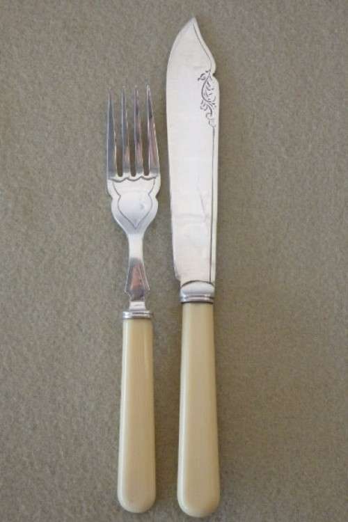 A stunning vintage bone handle style "fish knife and fork" set in its original wooden canteen