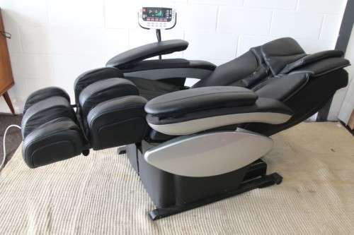 An incredible large automatic massage chair with electronic keypad and headphones