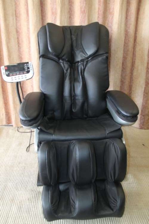 An incredible large automatic massage chair with electronic keypad and headphones