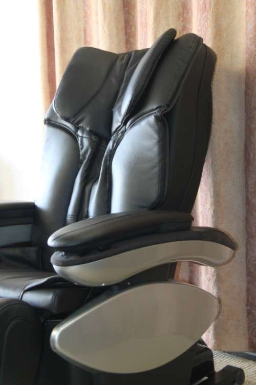 An incredible large automatic massage chair with electronic keypad and headphones