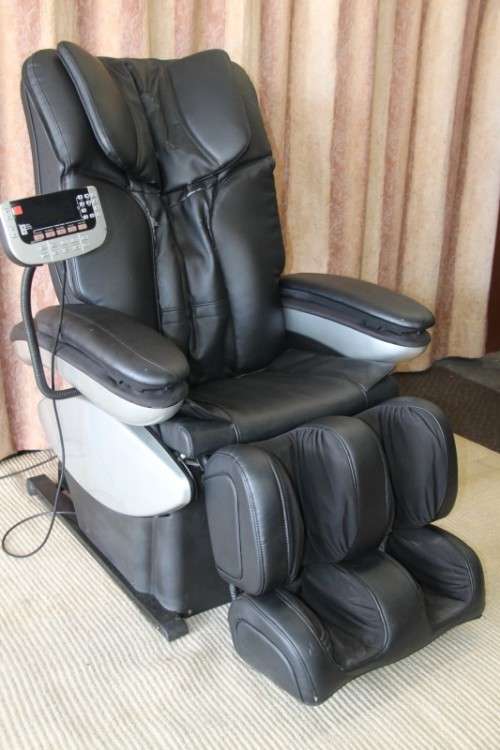 An incredible large automatic massage chair with electronic keypad and headphones