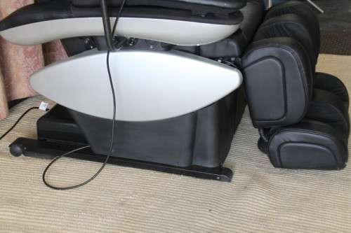 An incredible large automatic massage chair with electronic keypad and headphones