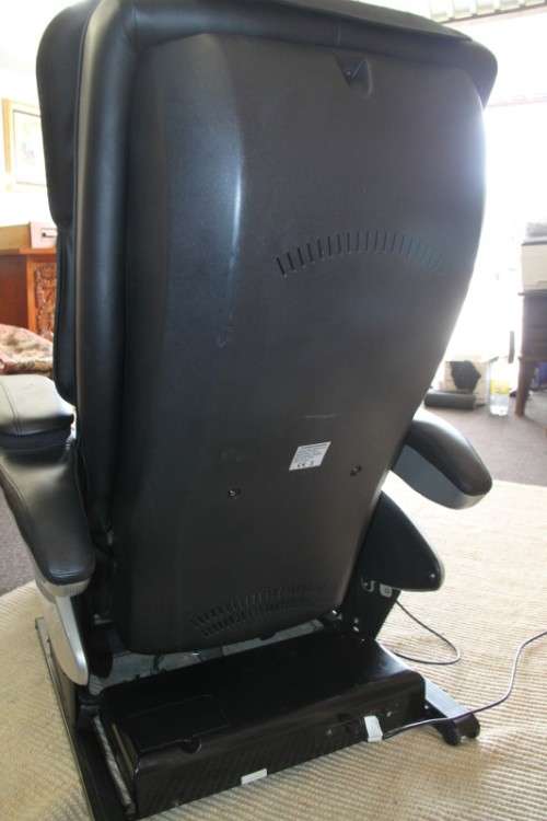An incredible large automatic massage chair with electronic keypad and headphones