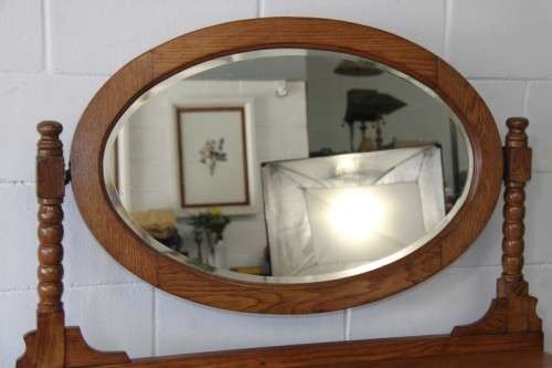 A magnificent antique solid oak dressing table w/ 6 drawers & a large beveled mirror on castors