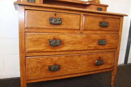 A magnificent antique solid oak dressing table w/ 6 drawers & a large beveled mirror on castors