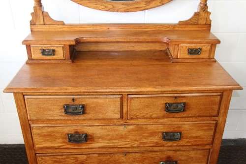 A magnificent antique solid oak dressing table w/ 6 drawers & a large beveled mirror on castors
