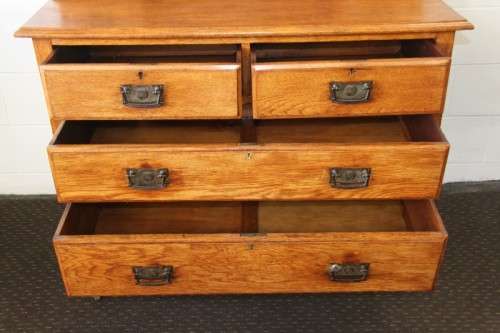A magnificent antique solid oak dressing table w/ 6 drawers & a large beveled mirror on castors