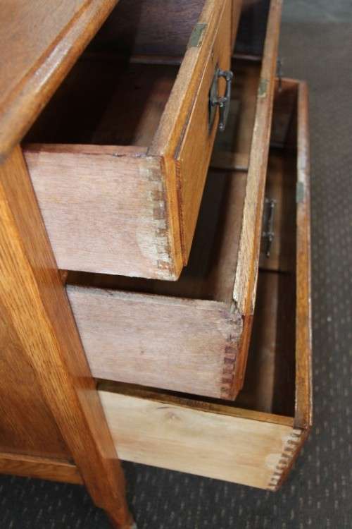 A magnificent antique solid oak dressing table w/ 6 drawers & a large beveled mirror on castors