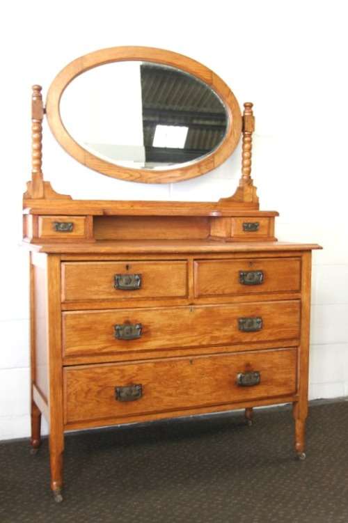 A magnificent antique solid oak dressing table w/ 6 drawers & a large beveled mirror on castors