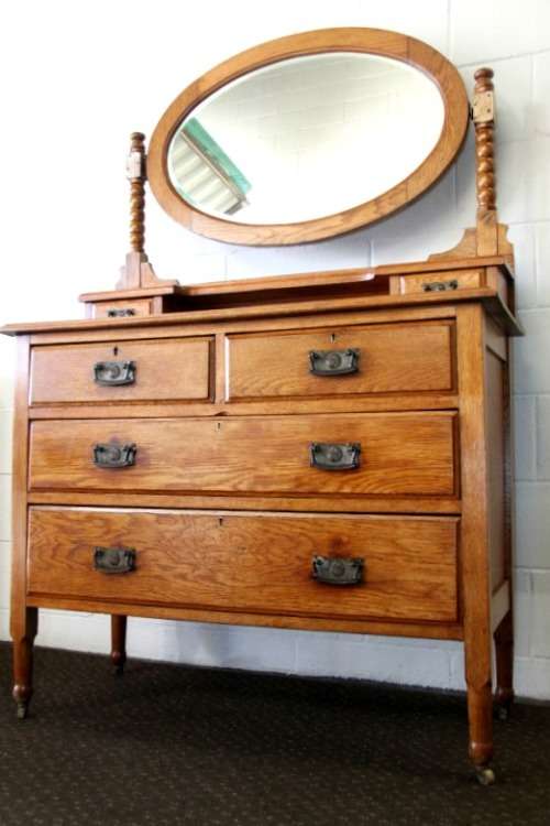 A magnificent antique solid oak dressing table w/ 6 drawers & a large beveled mirror on castors