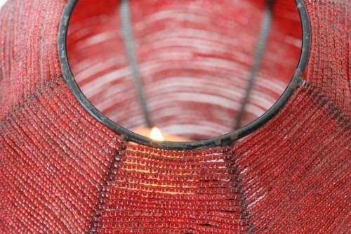 Two exquisite red beaded candle holders on a solid metal frame and metal feet; bid/holder