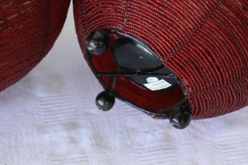 Two exquisite red beaded candle holders on a solid metal frame and metal feet; bid/holder