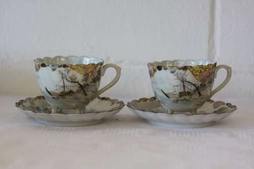 Two rare antique Japanese "translucent" porcelain teacups and saucers with amazing hand painted work