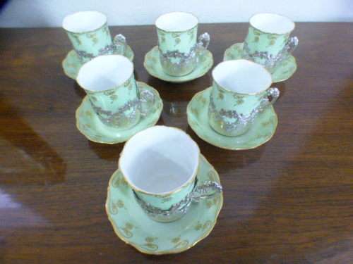Magnificent boxed antique Royal Worcester demitasse duo's with gold detailing in silver cup holders!