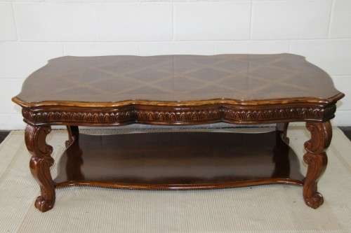 An awesome wooden centre coffee table with stunning inlay detailing and carved legs