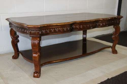 An awesome wooden centre coffee table with stunning inlay detailing and carved legs