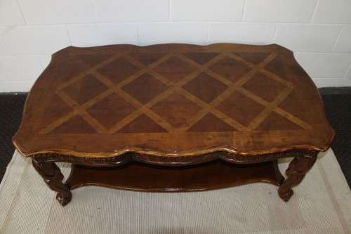An awesome wooden centre coffee table with stunning inlay detailing and carved legs