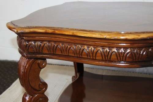 An awesome wooden centre coffee table with stunning inlay detailing and carved legs