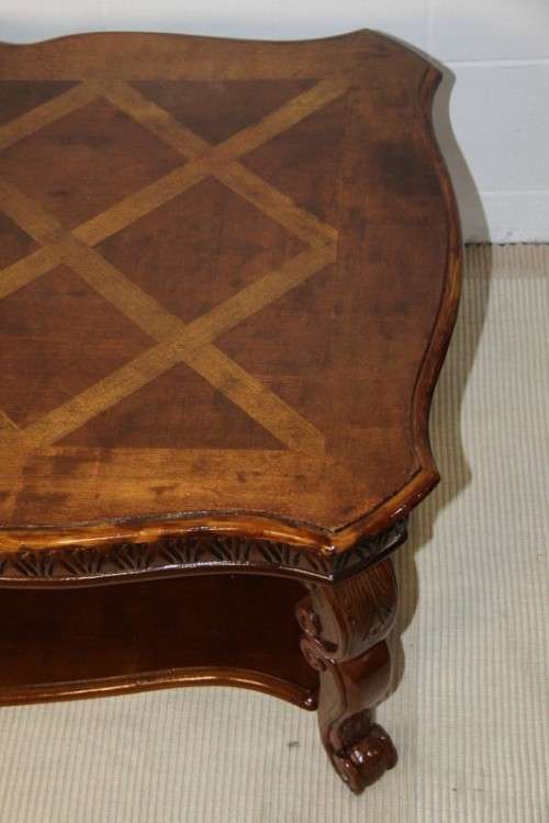 An awesome wooden centre coffee table with stunning inlay detailing and carved legs