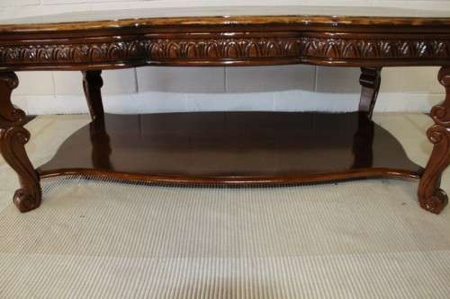 An awesome wooden centre coffee table with stunning inlay detailing and carved legs