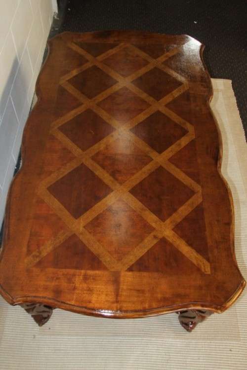 An awesome wooden centre coffee table with stunning inlay detailing and carved legs