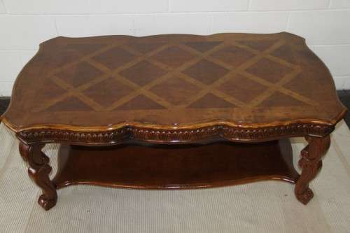 An awesome wooden centre coffee table with stunning inlay detailing and carved legs