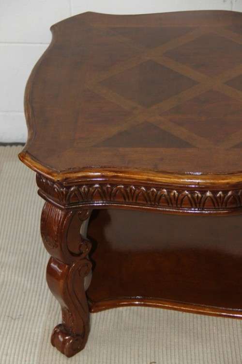 An awesome wooden centre coffee table with stunning inlay detailing and carved legs