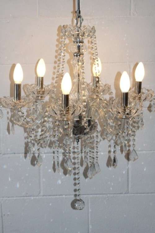A superb and expensive crystal chandelier with curved glass arms and 6x light fittings = wow!!!