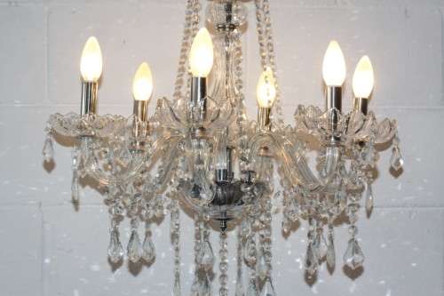 A superb and expensive crystal chandelier with curved glass arms and 6x light fittings = wow!!!