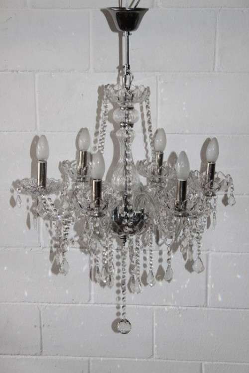 A superb and expensive crystal chandelier with curved glass arms and 6x light fittings = wow!!!