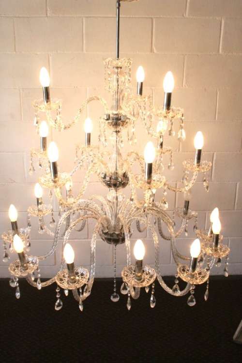 A spectacular three-tier crystal chandelier with curved glass arms and 21x light fittings = WOW!!