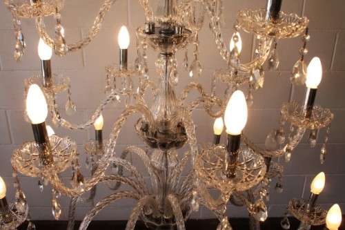 A spectacular three-tier crystal chandelier with curved glass arms and 21x light fittings = WOW!!