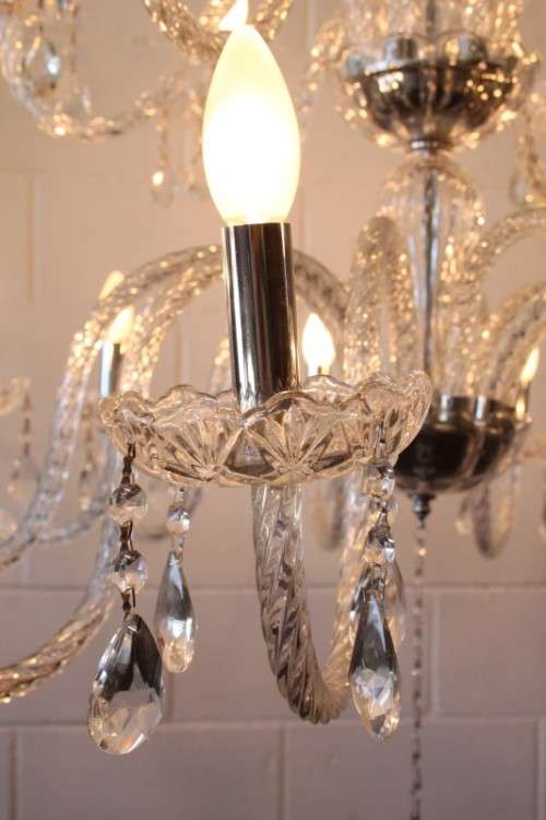 A spectacular three-tier crystal chandelier with curved glass arms and 21x light fittings = WOW!!