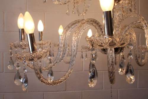 A spectacular three-tier crystal chandelier with curved glass arms and 21x light fittings = WOW!!