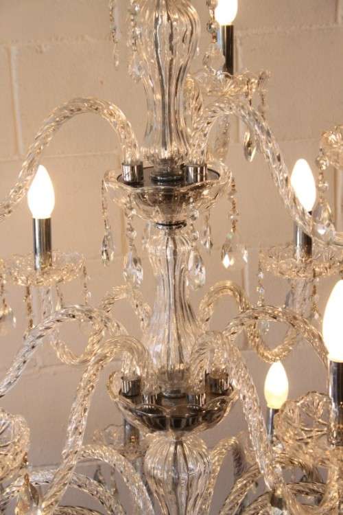 A spectacular three-tier crystal chandelier with curved glass arms and 21x light fittings = WOW!!