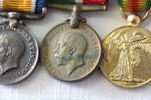Four magnificent antique miniature ribboned military medals in very good condition