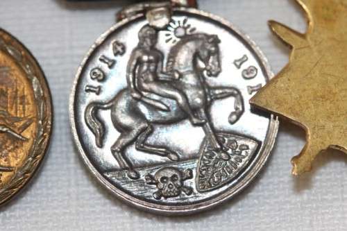 Four magnificent antique miniature ribboned military medals in very good condition