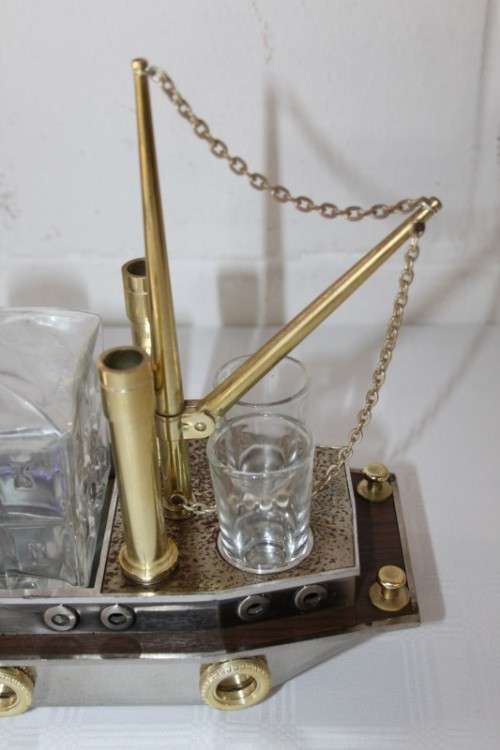An amazing vintage tugboat decanter with a wind-up music box and four shot glasses