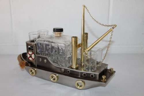 An amazing vintage tugboat decanter with a wind-up music box and four shot glasses