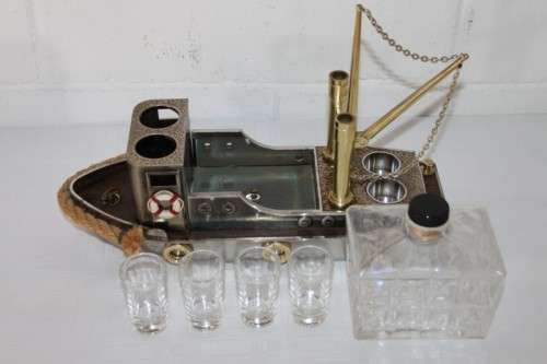 An amazing vintage tugboat decanter with a wind-up music box and four shot glasses