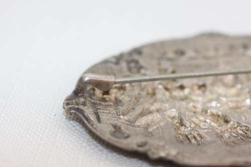 An incredible original antique Herbert Hooijkaas silver plated repousse brooch and earring set