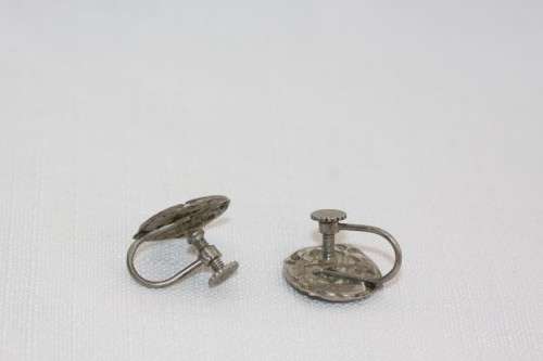 An incredible original antique Herbert Hooijkaas silver plated repousse brooch and earring set