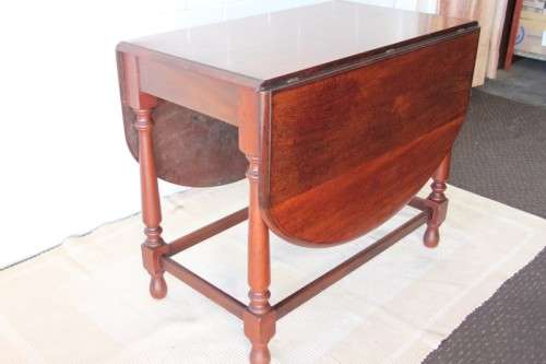 A wonderful solid teak "drop-leaf" table w/ side panels, very compact and perfect for limited space