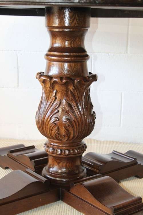 A very well made and heavy oak dining table w/ a wonderfully carved centre leg
