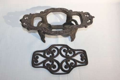 A cast iron pot warmer with space for two tealight candles, something special for dinner parties