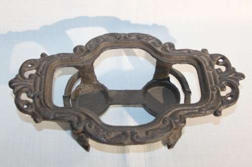A cast iron pot warmer with space for two tealight candles, something special for dinner parties