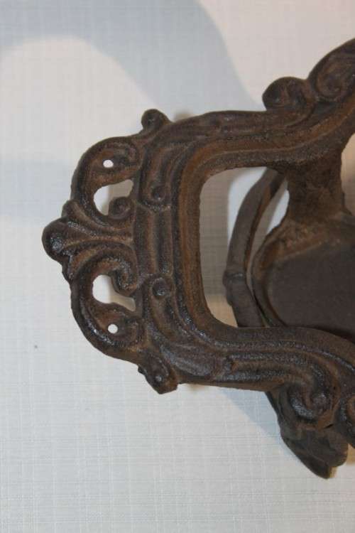 A cast iron pot warmer with space for two tealight candles, something special for dinner parties