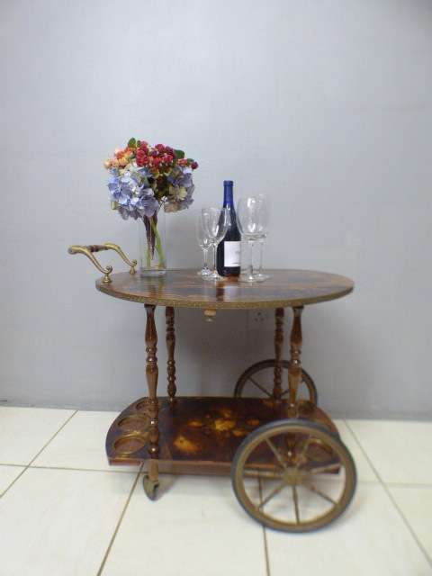 An exquisite Italian Sorrento style wood antique drinks trolley on original castors and wheels.